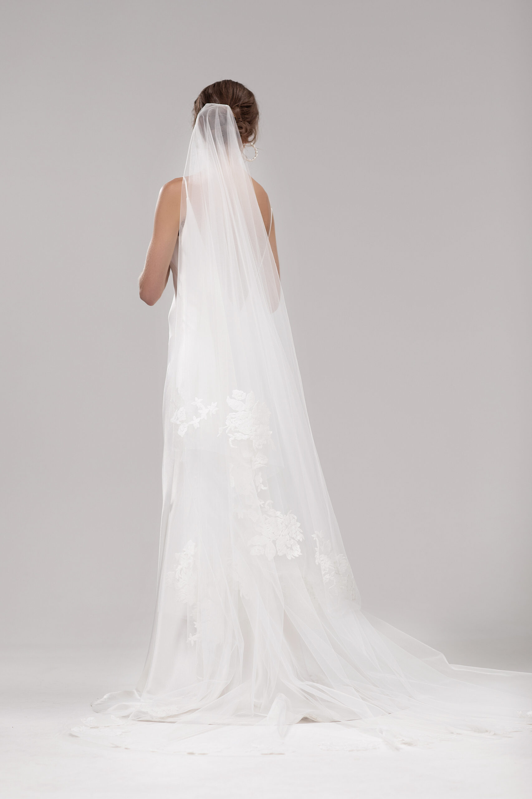 Back view of model wearing the Mayfair veil, a two-tier 2.5m veil with delicate floral embroidery around the edge.