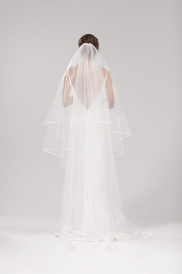 Back view of model wearing Snow with two tiers down the back. Snow is a 2.5m two-tier blusher style veil with an organza binding on the edge.