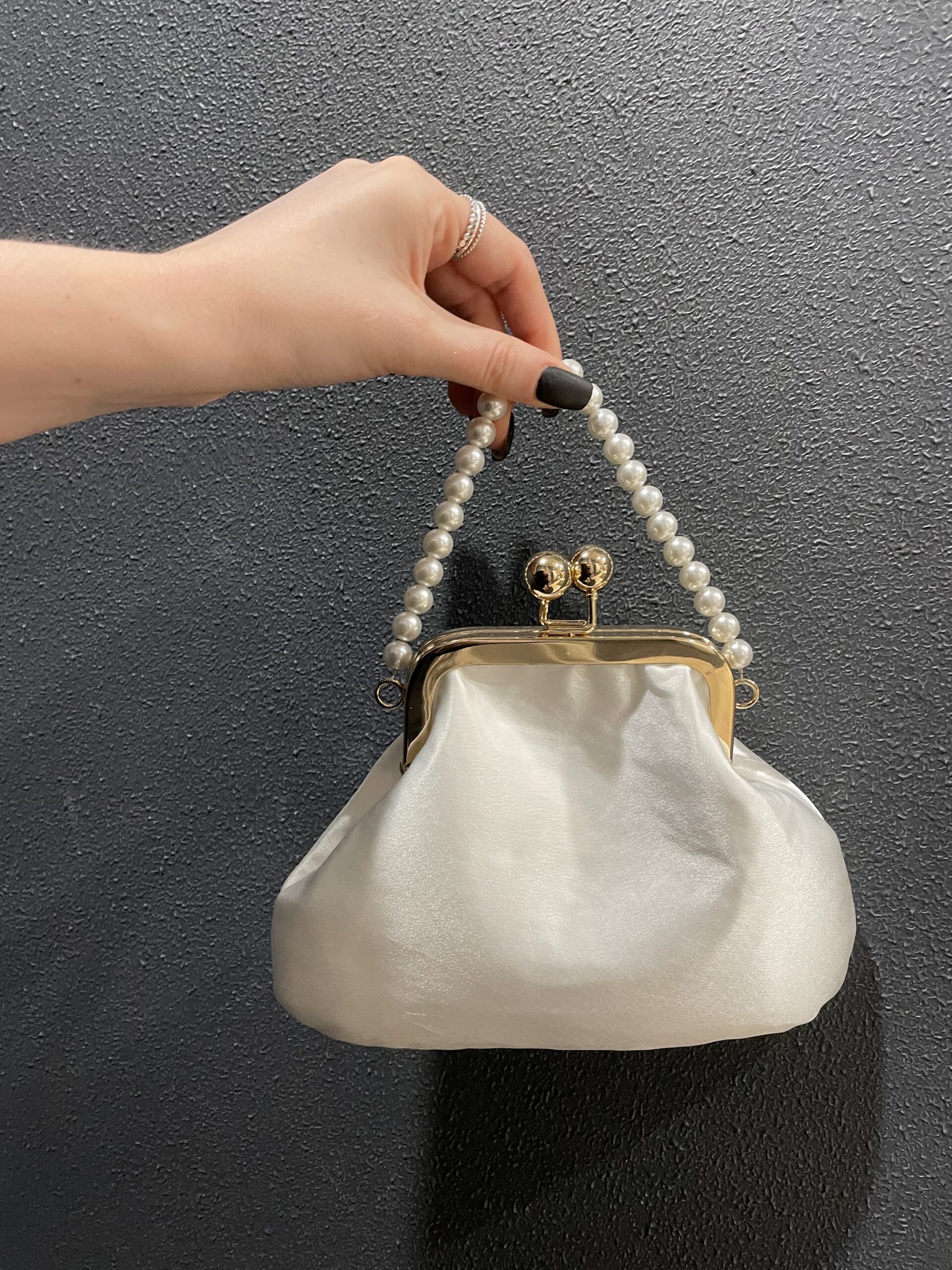 Basra - a satin clutch with a pearl strap and a gold kiss-lock.