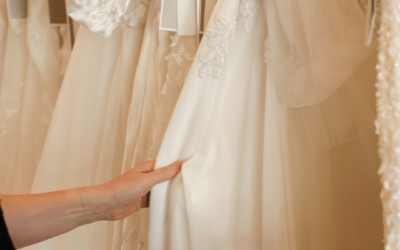 Designer Liz flicking through gowns on the rack in our Norwood boutique.