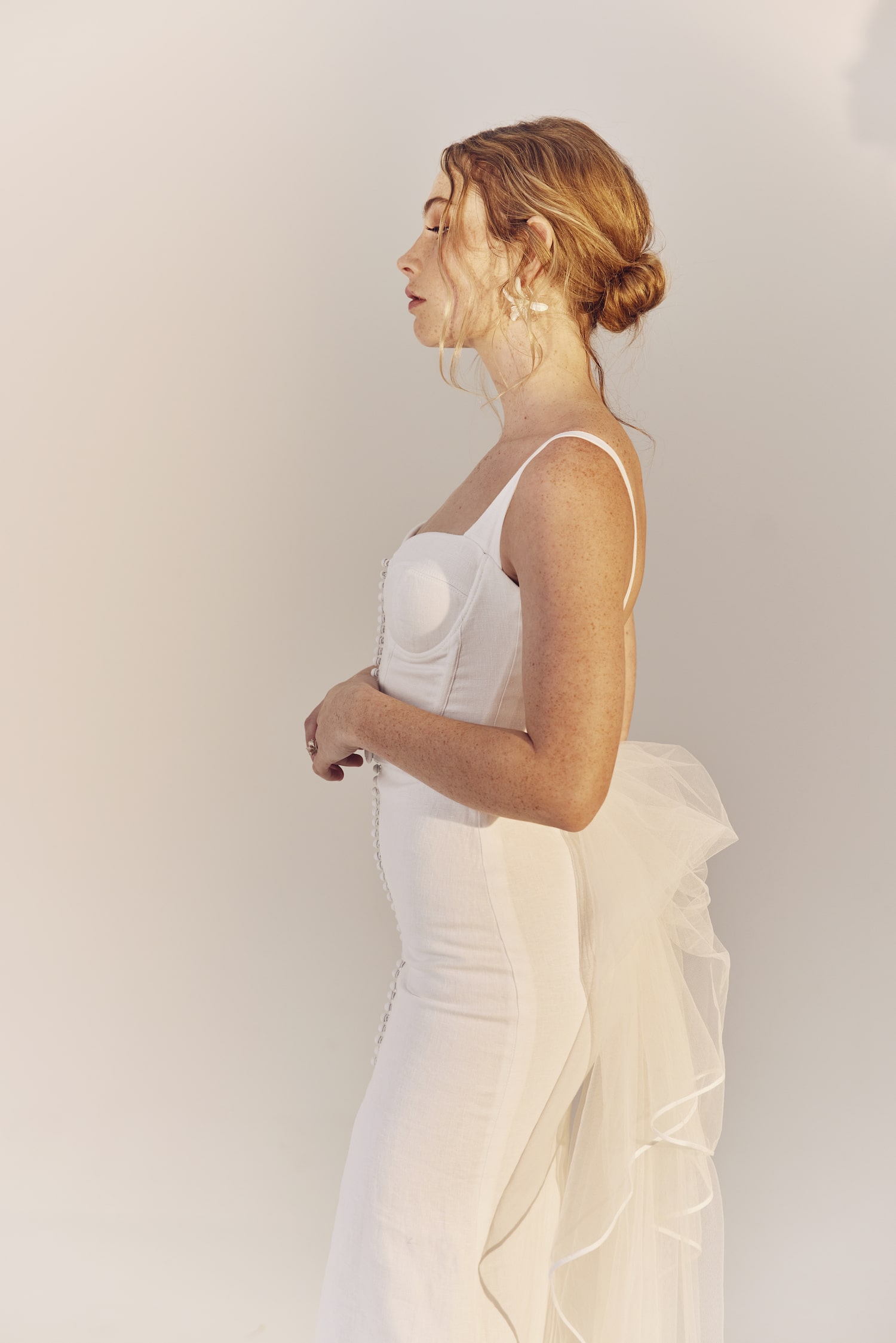 Vera side view - white linen corset bodice with slim fitting skirt and front skirt split