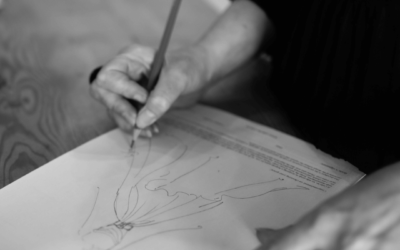 Close up image of head designer Liz drawing a sketch of a gown