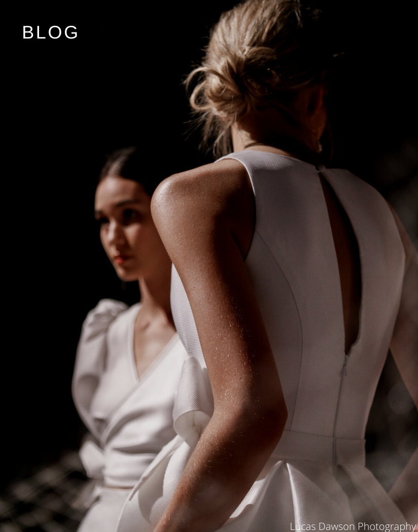 Image of models behind the scenes of Adelaide fashion festival - model close up is wearing Tokyo gown