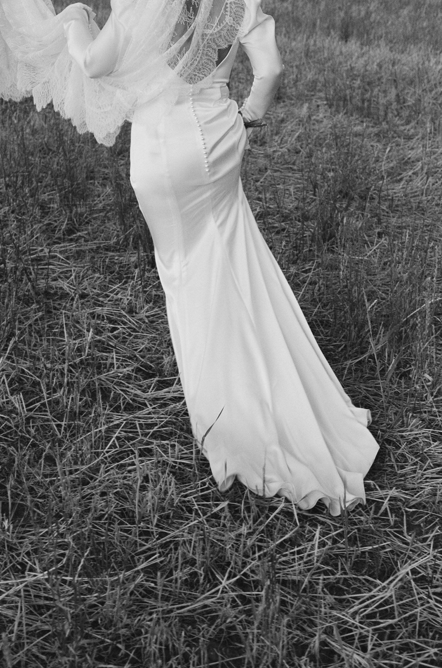 Back view of bride's gown while she is walking.