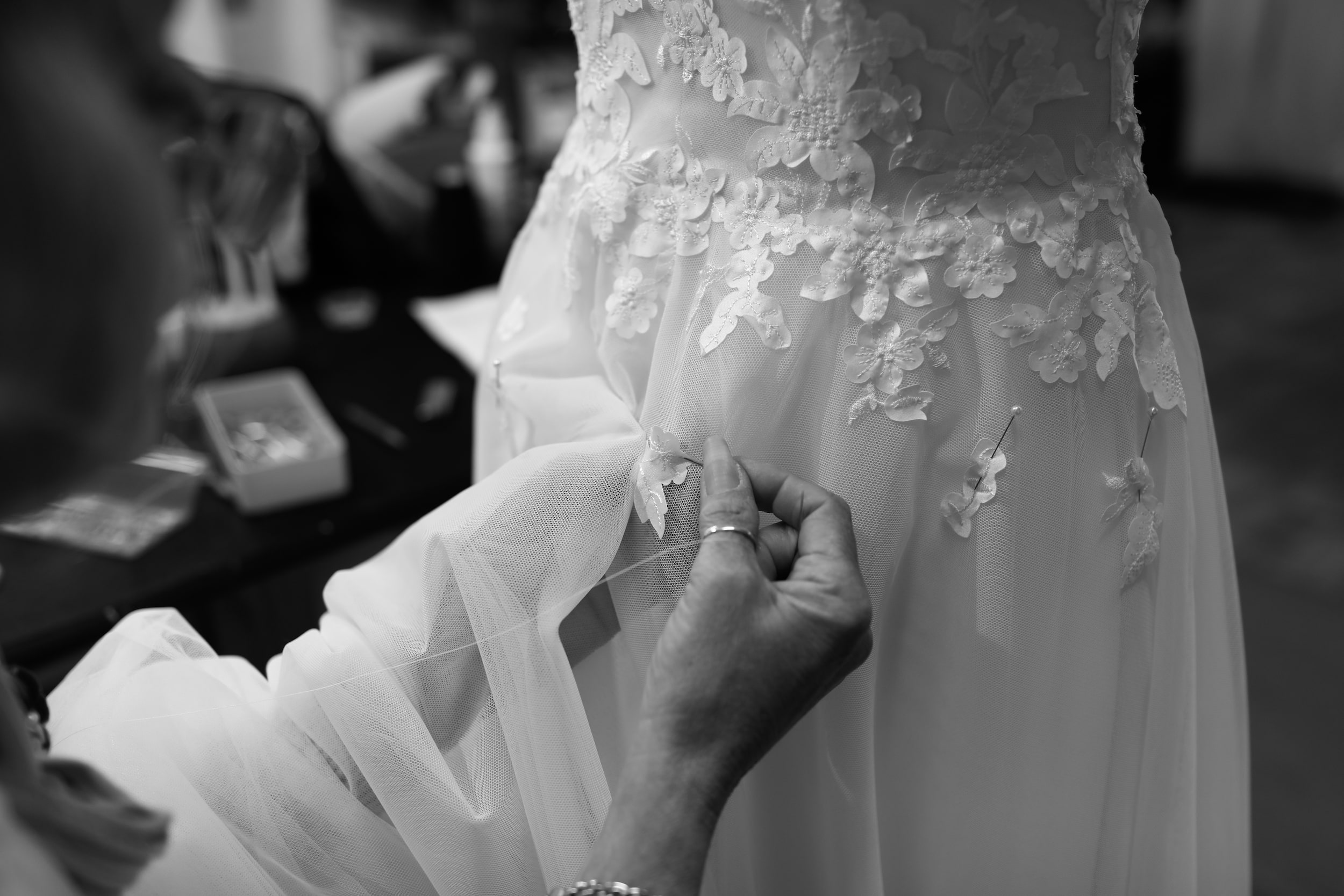 Hand-worker stitching lace onto a custom wedding dress