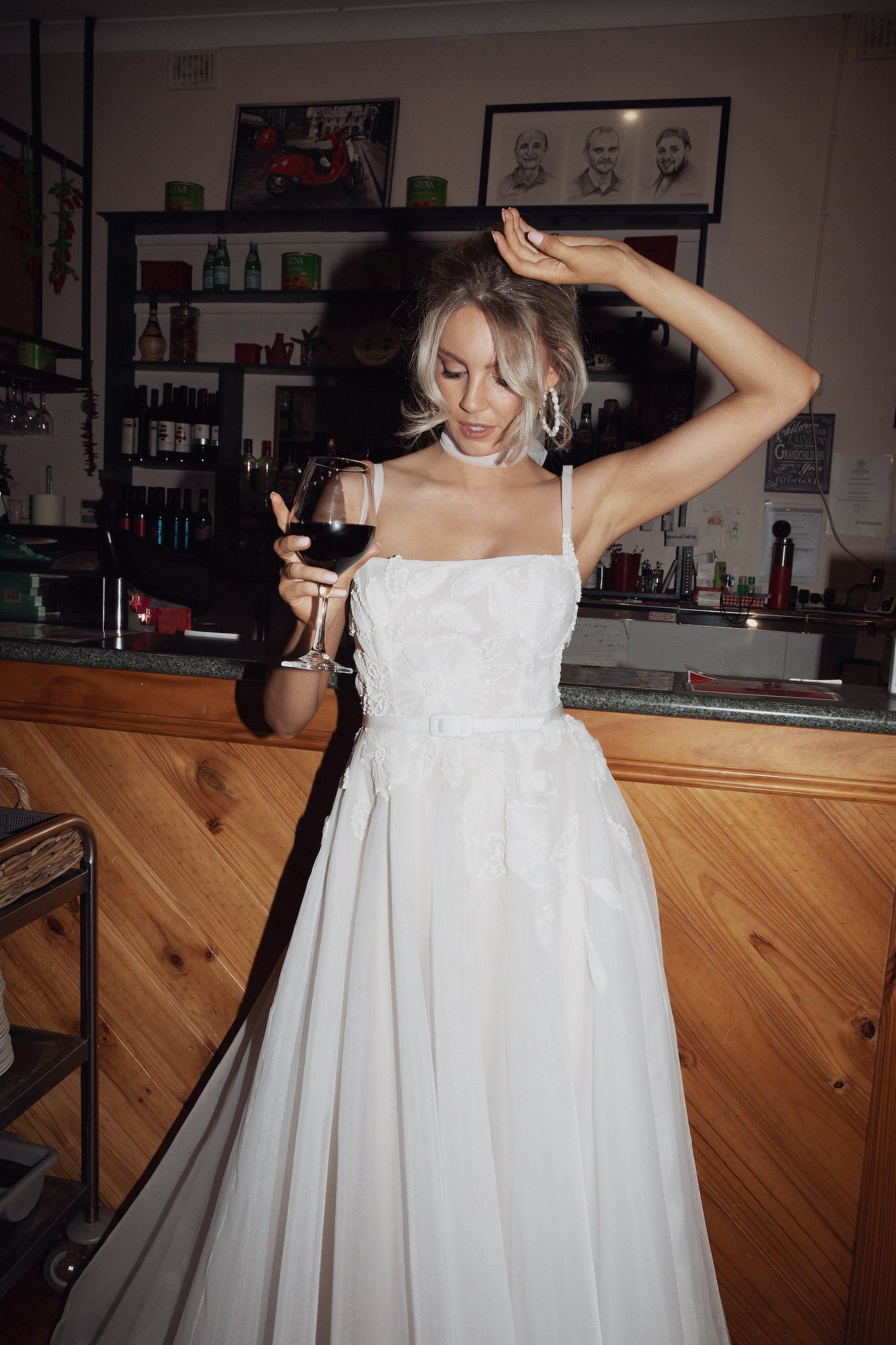 Model posing in Italian cafe wearing the Fiorella gown.