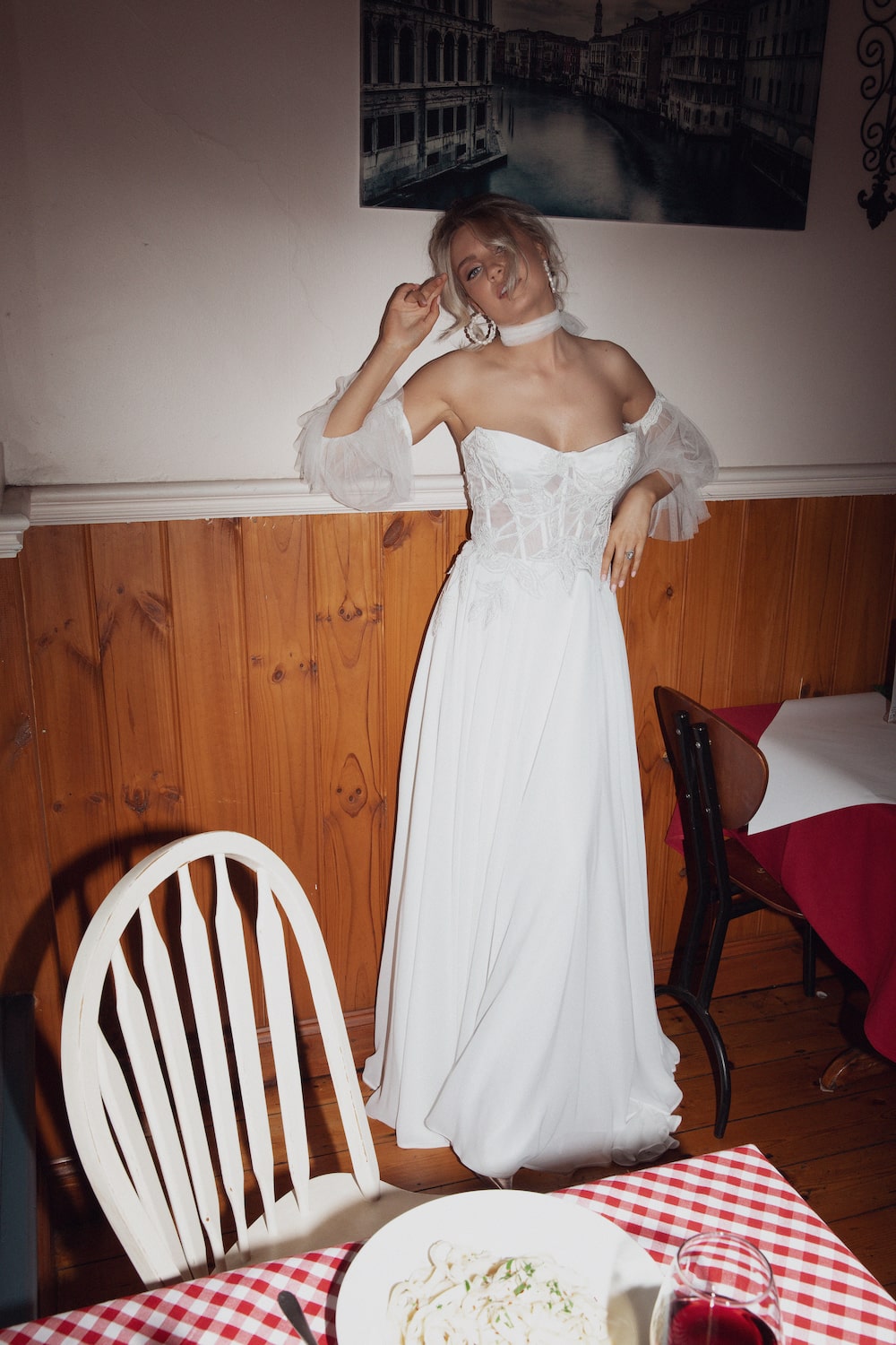 Model posing in italian cafe wearing the Giulietta gown.