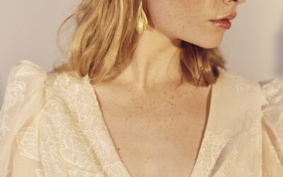 Close up image of the wrap-over V neckline of the Rosa gown. Rosa is made of an embroidered silk/cotton.