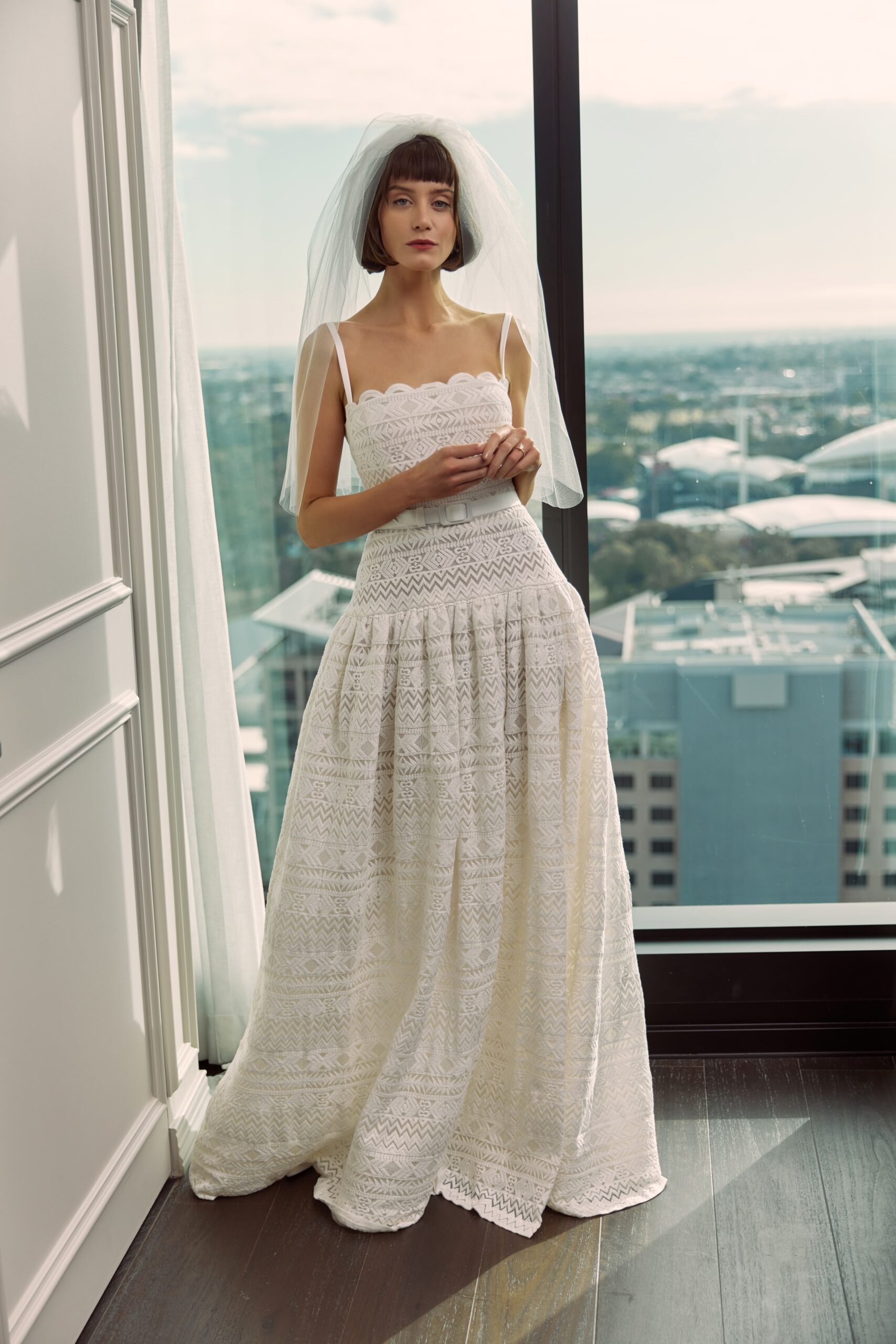 Lucille - An embroidered cotton gown with a drop waist, thin straps, belt and leg split.