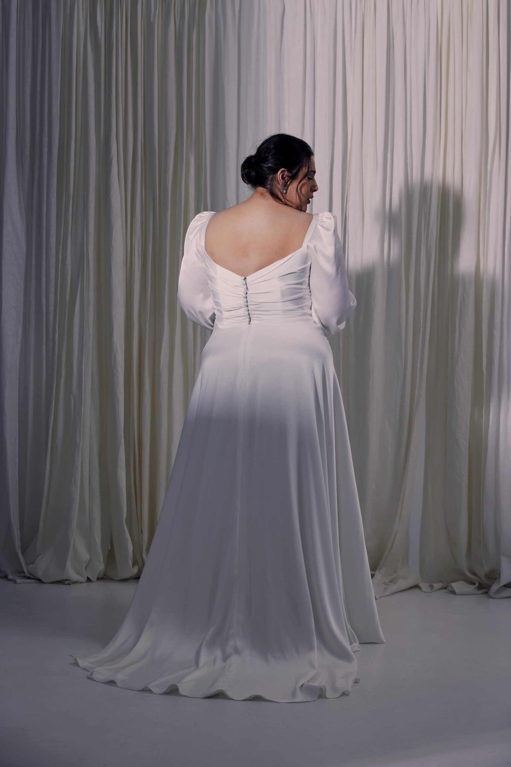 The Luna gown - a satin gown with soft bodice draping, soft bishop sleeves and a soft flowing a-line skirt.