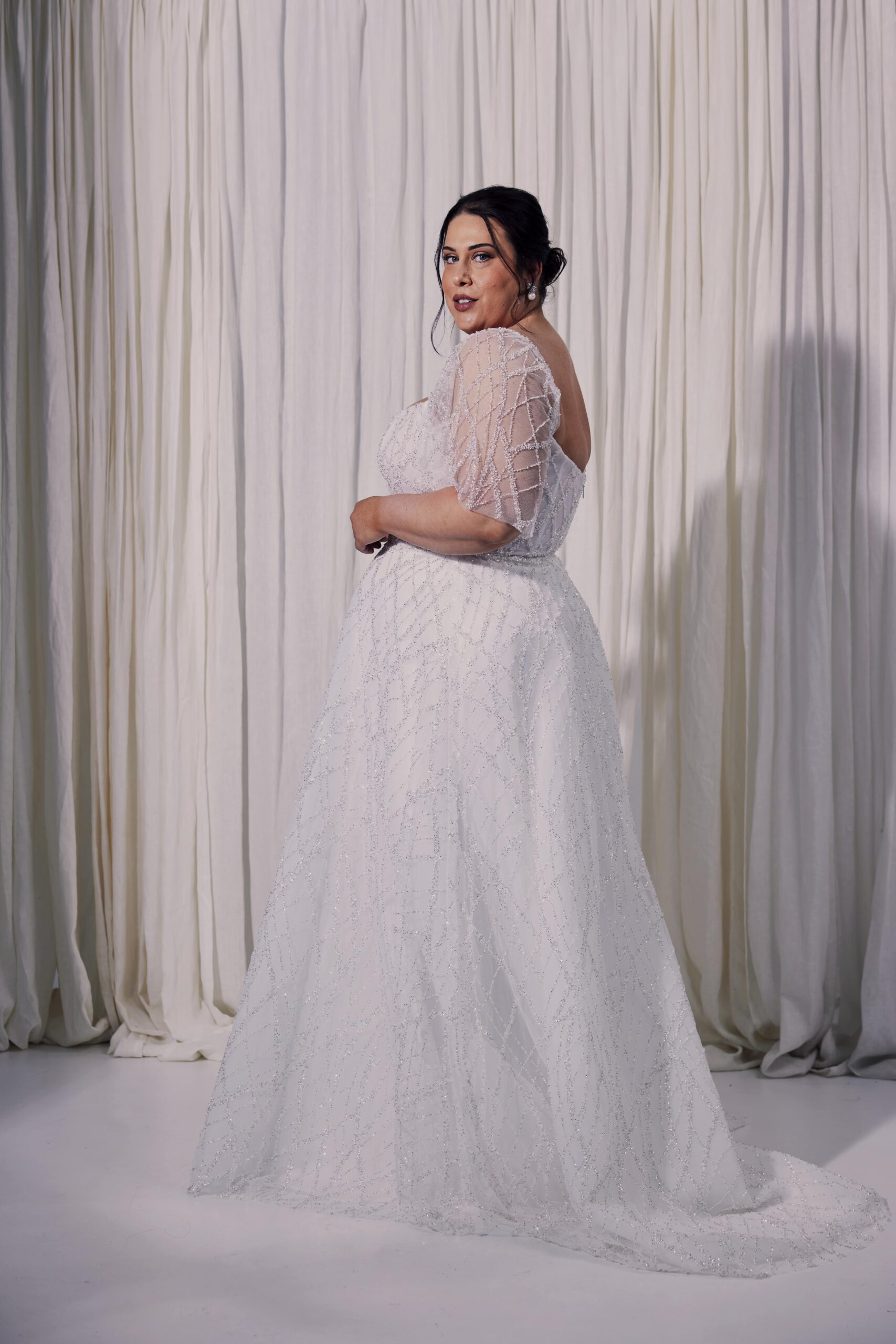 The Diamond gown - a beaded tulle A-line gown with a structured corset bodice, square neckline and flutter sleeves.