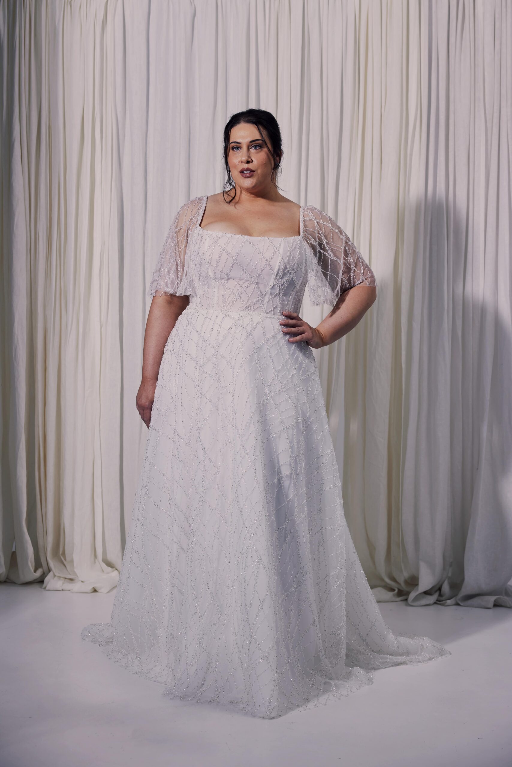 The Diamond gown - a beaded tulle A-line gown with a structured corset bodice, square neckline and flutter sleeves.