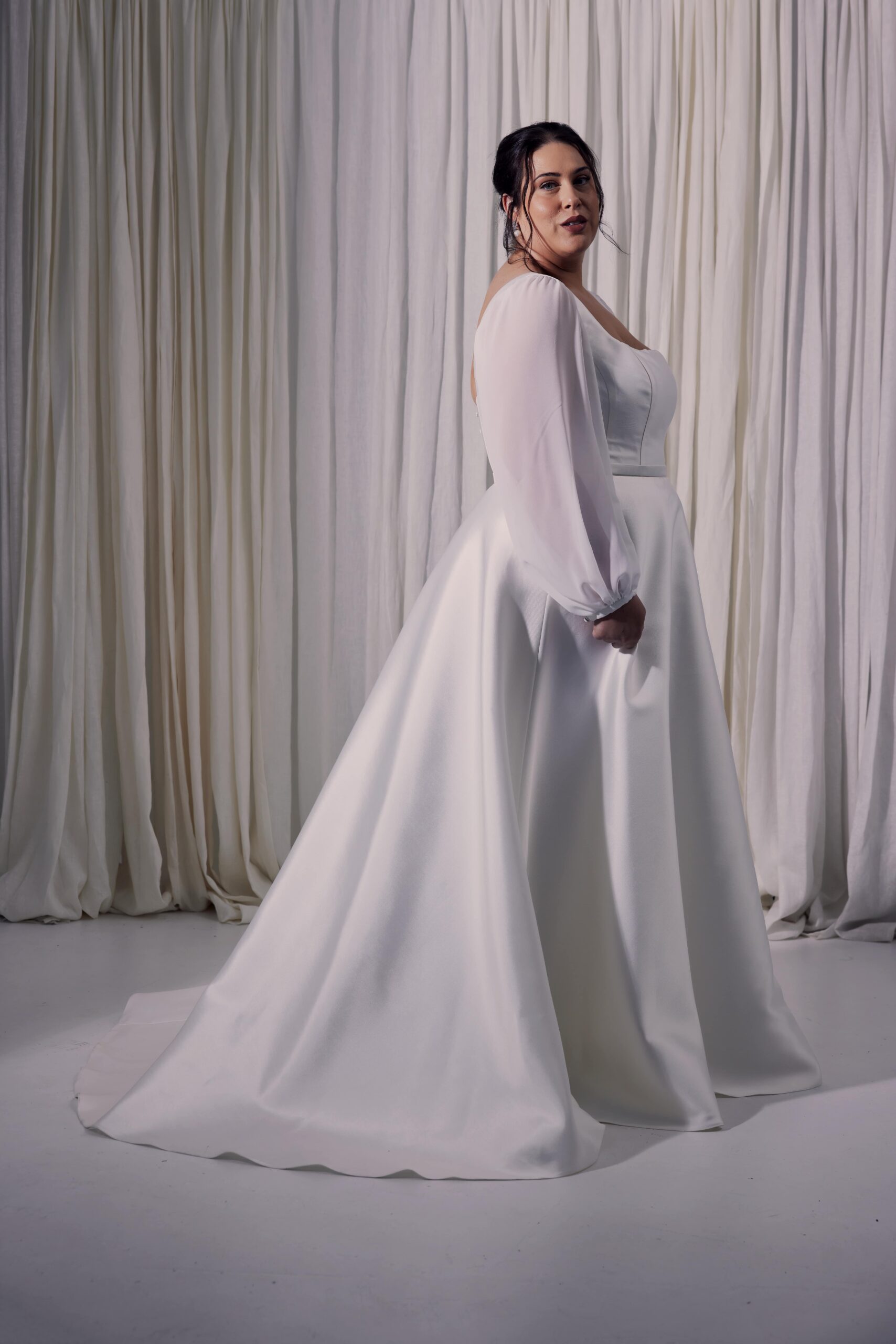 The Geneva gown - an A-line twill gown with a square neckline, soft georgette sleeves and a full skirt.