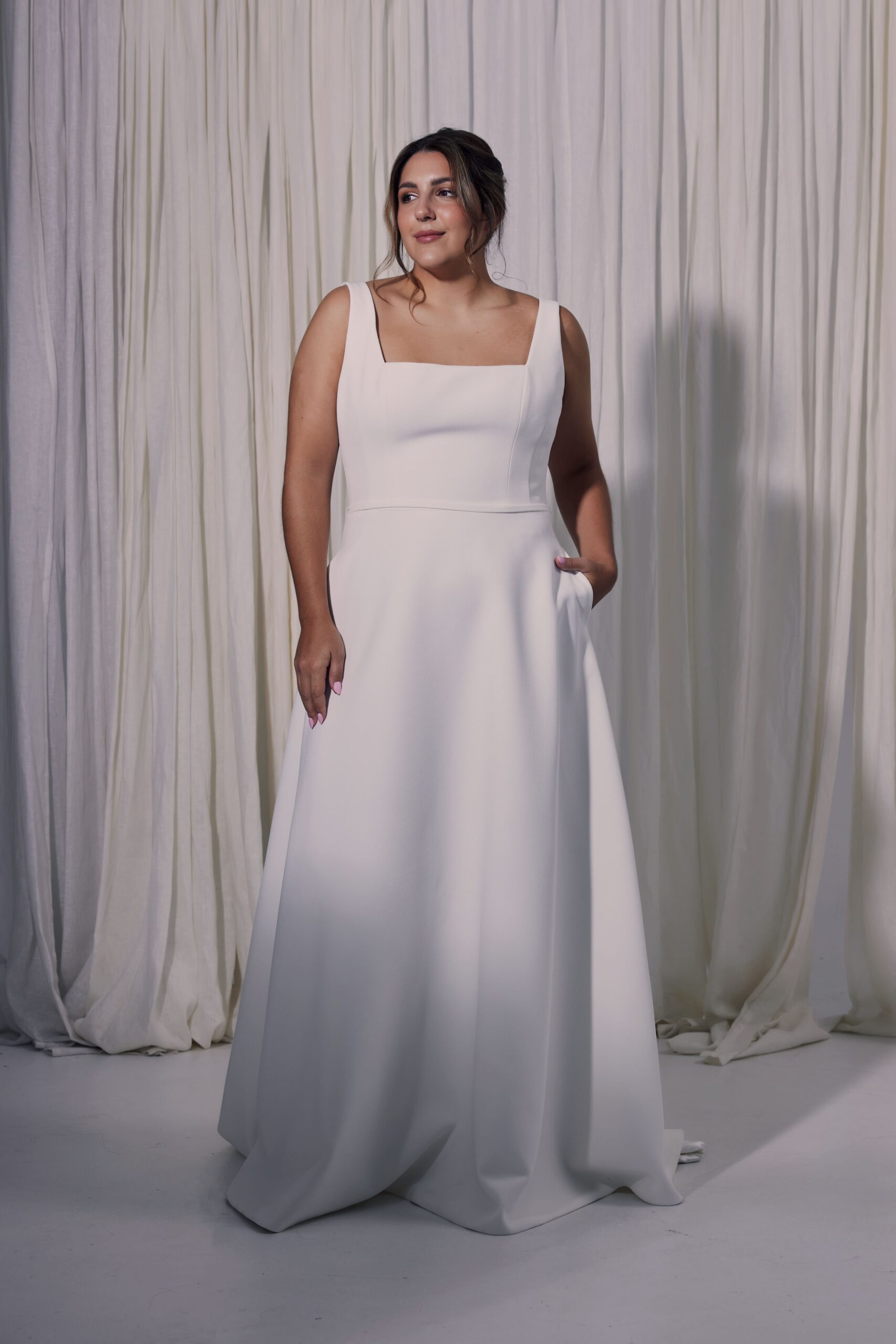 The Tora gown - a double crepe A-line gown with a square neckline.