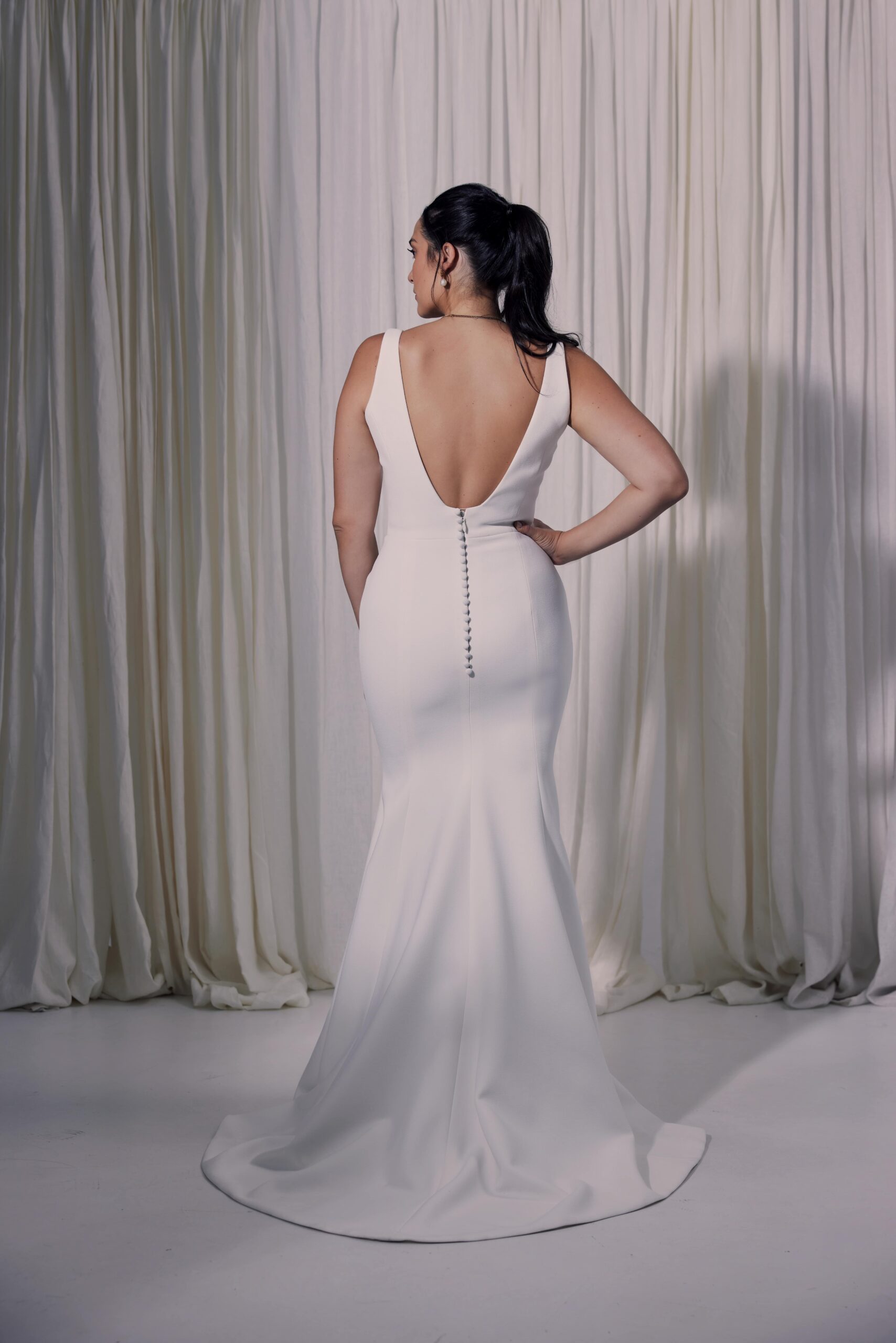 The Trevi gown - a sculpted fit and flare silhouette in double crepe with a modern square neckline.