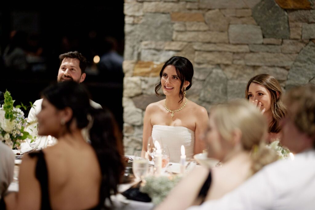 Maddy and Jason listening to speeches at the reception