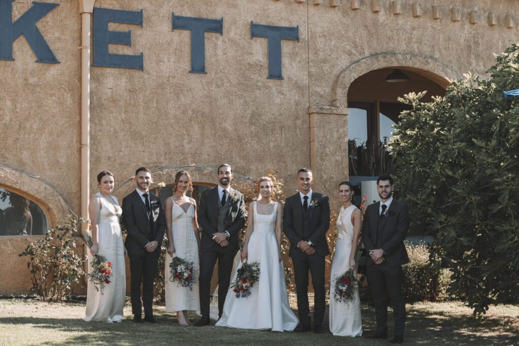 Bridal party standing in front of Winery