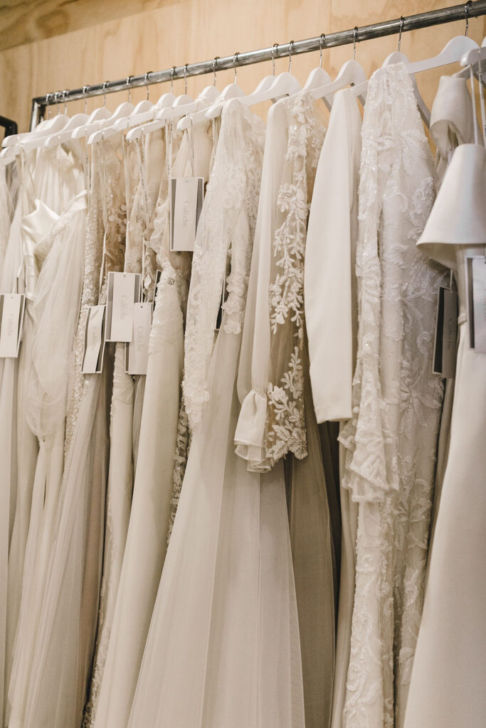 Rack of bridal gowns in Calèche boutique