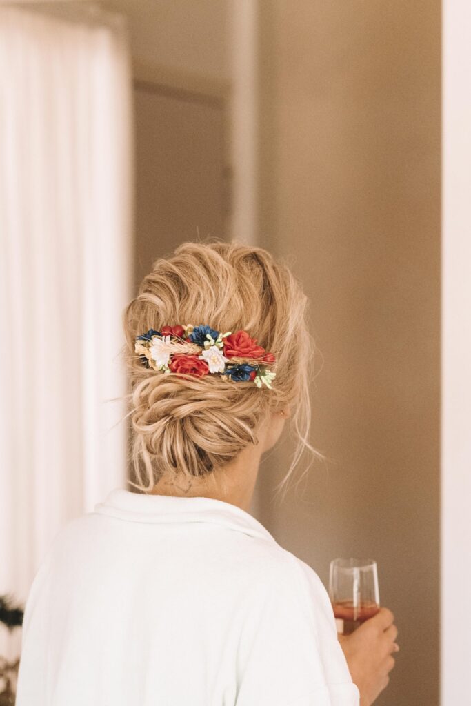 Maia getting ready - drinking bubbly and showing a floral hairpiece in her hair