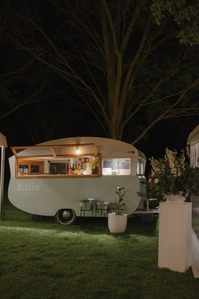 Kombi drinks bar lit up in the night evening.